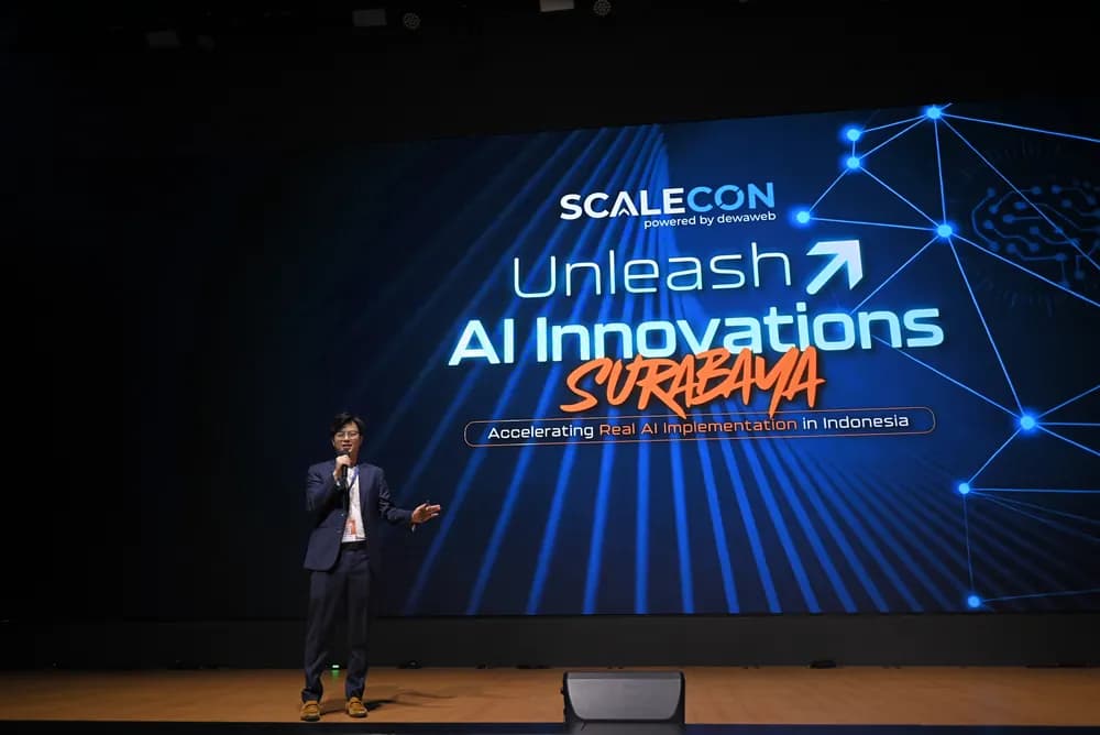 A speaker alone on the wide main stage at SCALECON Surabaya 2026
