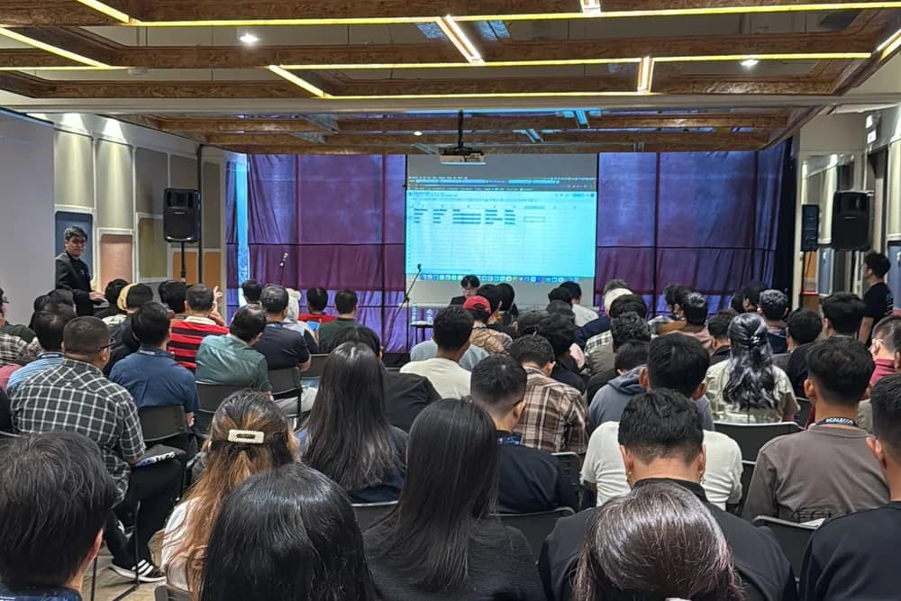 Attendees following a live walkthrough on the workshop screen at a previous SCALECON
