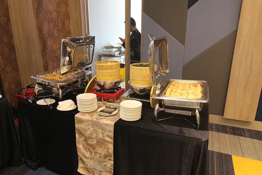 Warming trays and stacked plates set out for lunch at a previous SCALECON